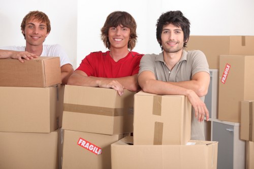 Movers carrying boxes near a Knightsbridge apartment building