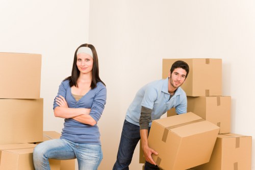 Commercial movers handling office equipment in a central London building